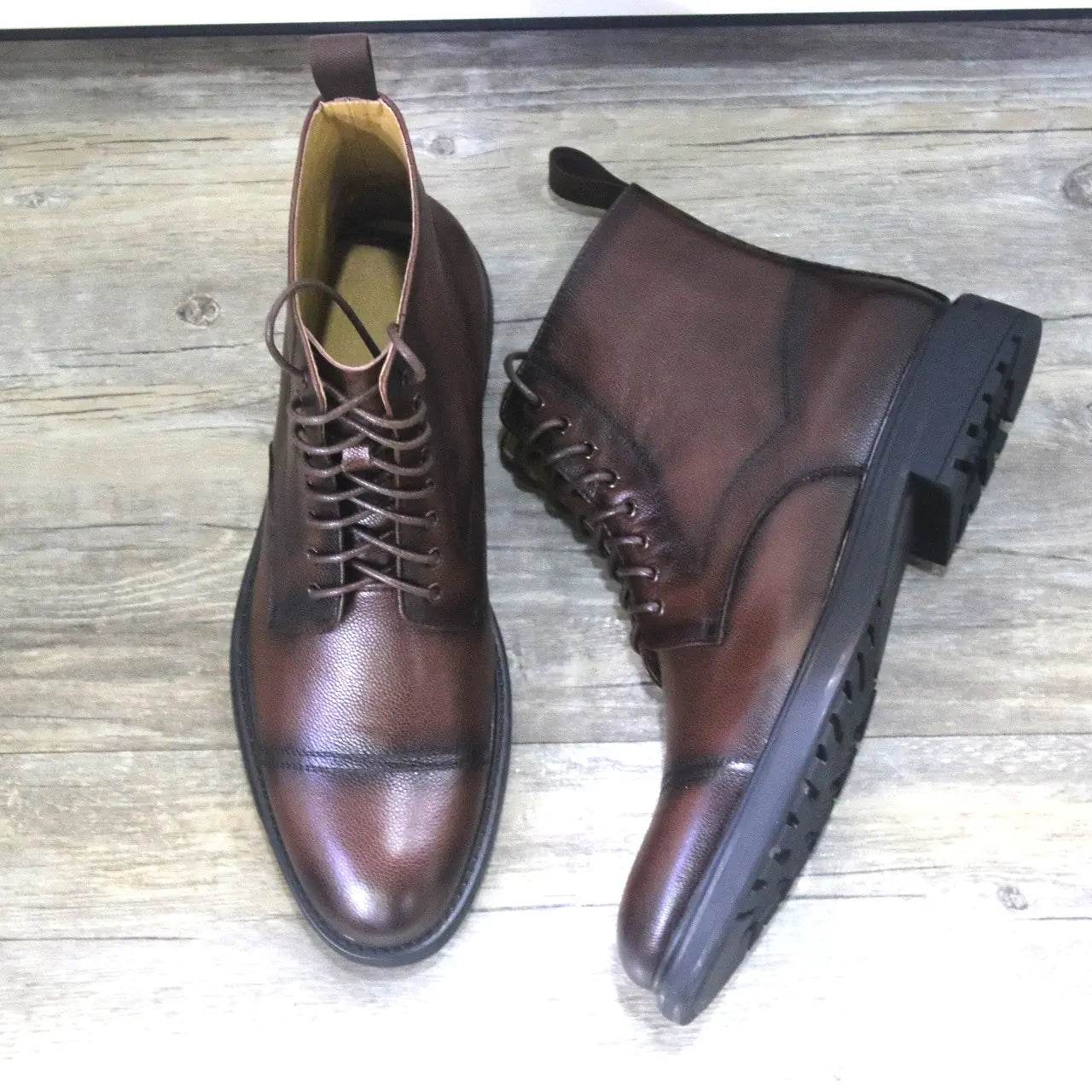 Solstik men's black leather formal boots with lace-up design and rugged sole on wooden floor