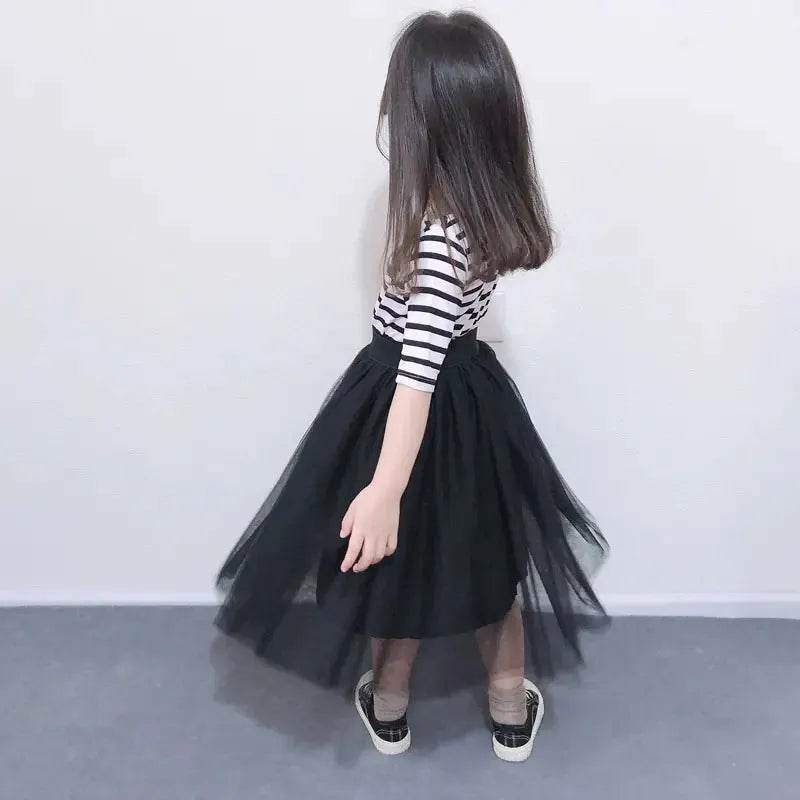 Little girl wearing black tulle skirt and striped top outfit, part of mother daughter matching outfits by Solstik