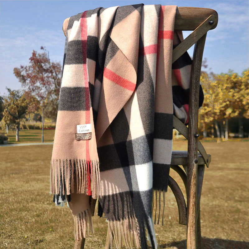 Solstik premium cozy wool scarf with plaid pattern draped on wooden chair outdoors