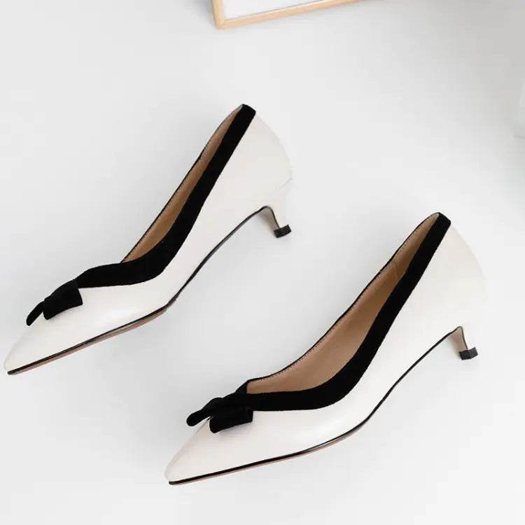 Solstik white kitten heels with black trim featuring red kitten heels with bow detail