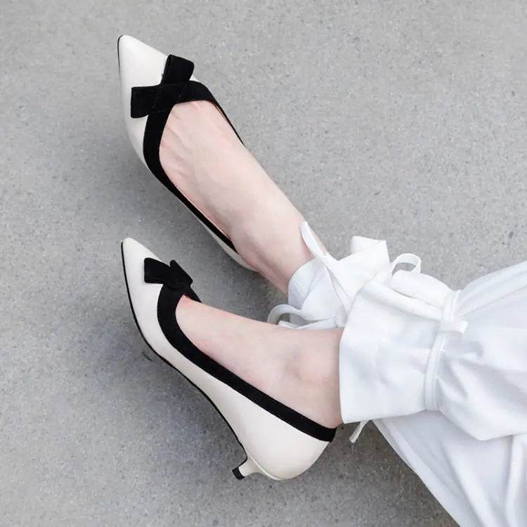 Solstik white kitten heels with black bow and trim in a stylish pointed toe design