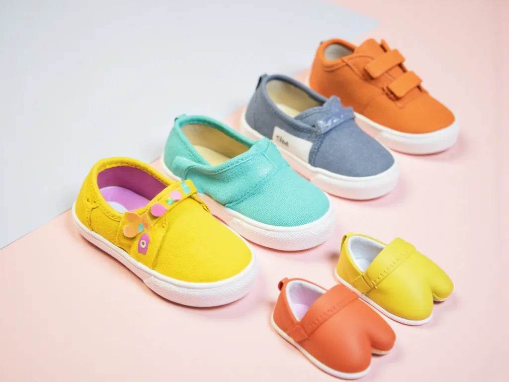 Colorful collection of children's shoes including slip-ons and velcro sneakers for active kids
