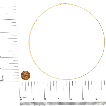 14k gold herringbone chain necklace displayed flat with ruler and penny for size reference