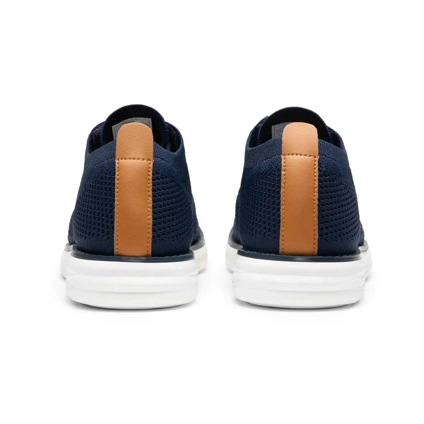 Solstik lightweight men's sneakers in navy blue with white soles and brown heel accents shown from the back