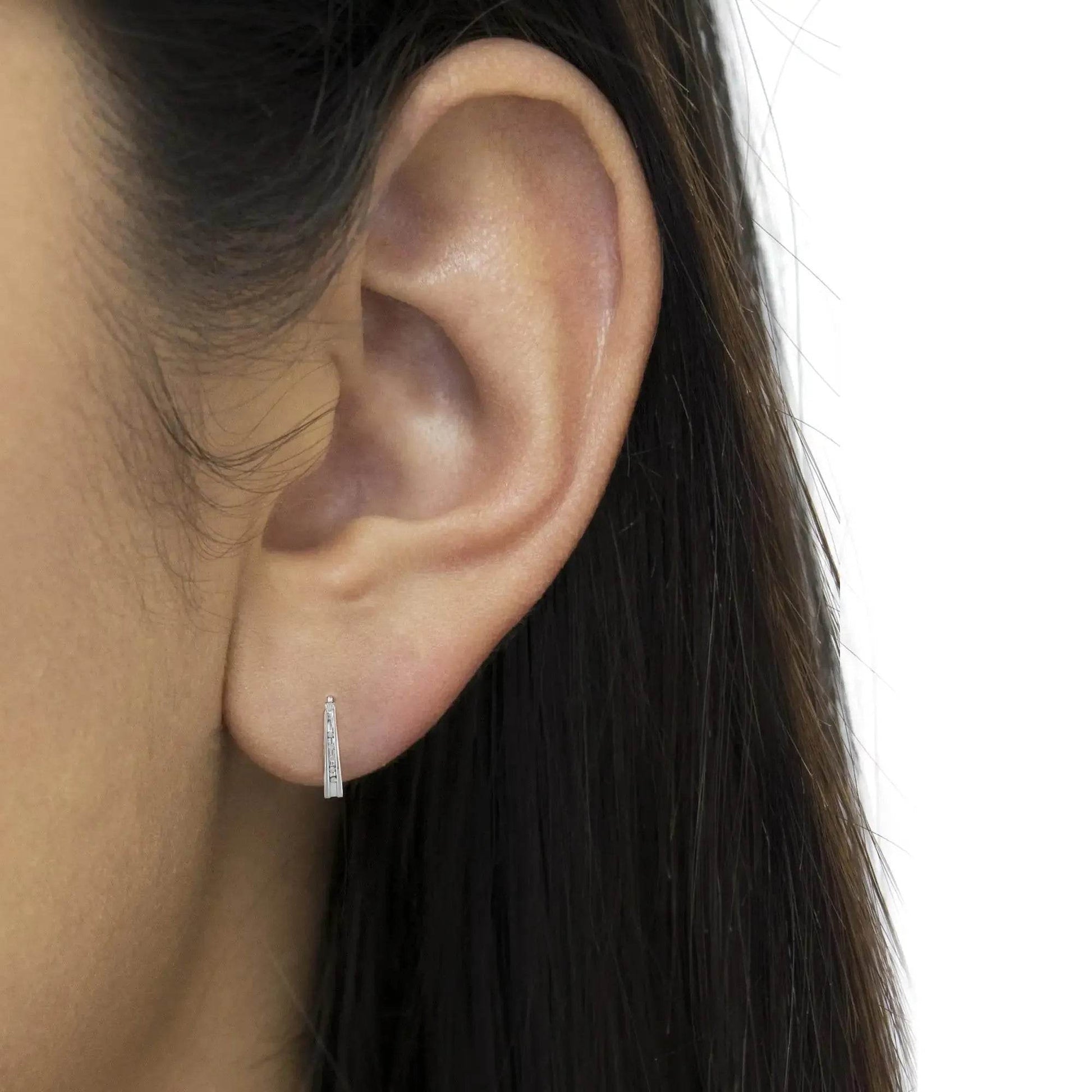 Solstik diamond accent silver hoops worn on ear small sparkling huggie earrings for everyday wear