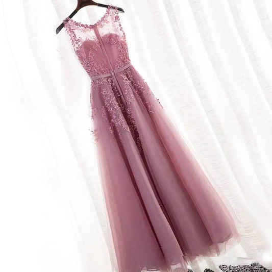 Solstik luxury bridesmaid gown for summer in dusty rose with floral lace detailing and sheer neckline