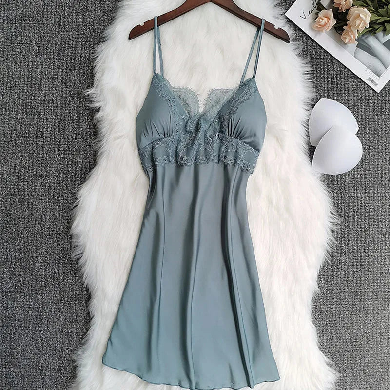 Solstik luxury silk robe set featuring a soft teal slip dress with lace detailing on a white fur background