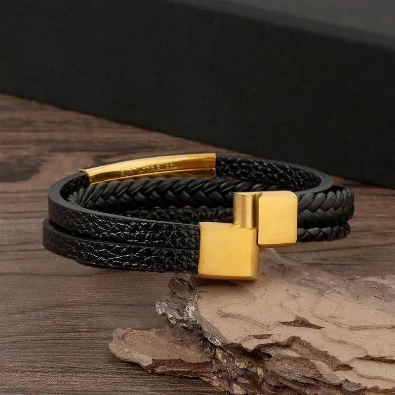 Solstik men's braided leather wristband with black braided design and gold clasp accents