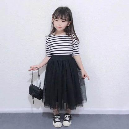 Little girl in black tulle skirt and striped top holding black purse mother daughter matching outfits