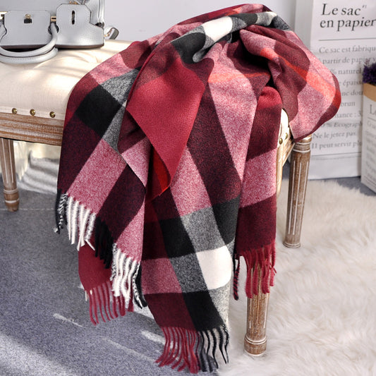 Solstik premium cozy wool scarf in red black and white plaid pattern draped over wooden chair