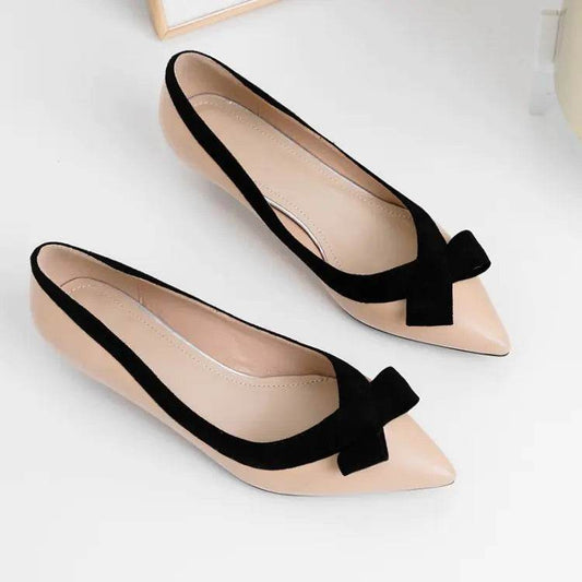 Solstik beige and black kitten heels with bow detailing on a white background
