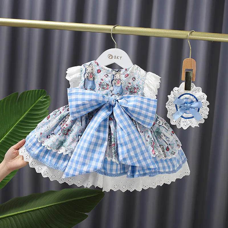 Solstik princess gown for girls with floral pattern and large blue checkered bow on hanger