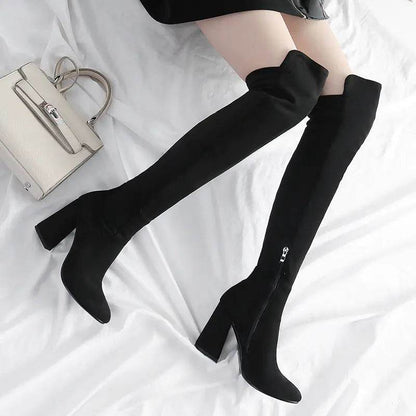 Black velvet stretch thigh high boots with block heels and side zipper worn with a black skirt