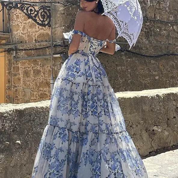 Solstik off-shoulder evening gown in white with blue floral pattern and corset back detail