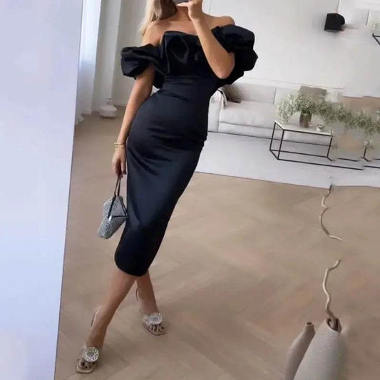 Woman wearing elegant black off shoulder dress with puff sleeves in modern living room, white chic cocktail dress